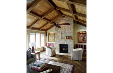 living room with high vaulted wood coffer ceiling, wood parquet floor and stone fireplace
