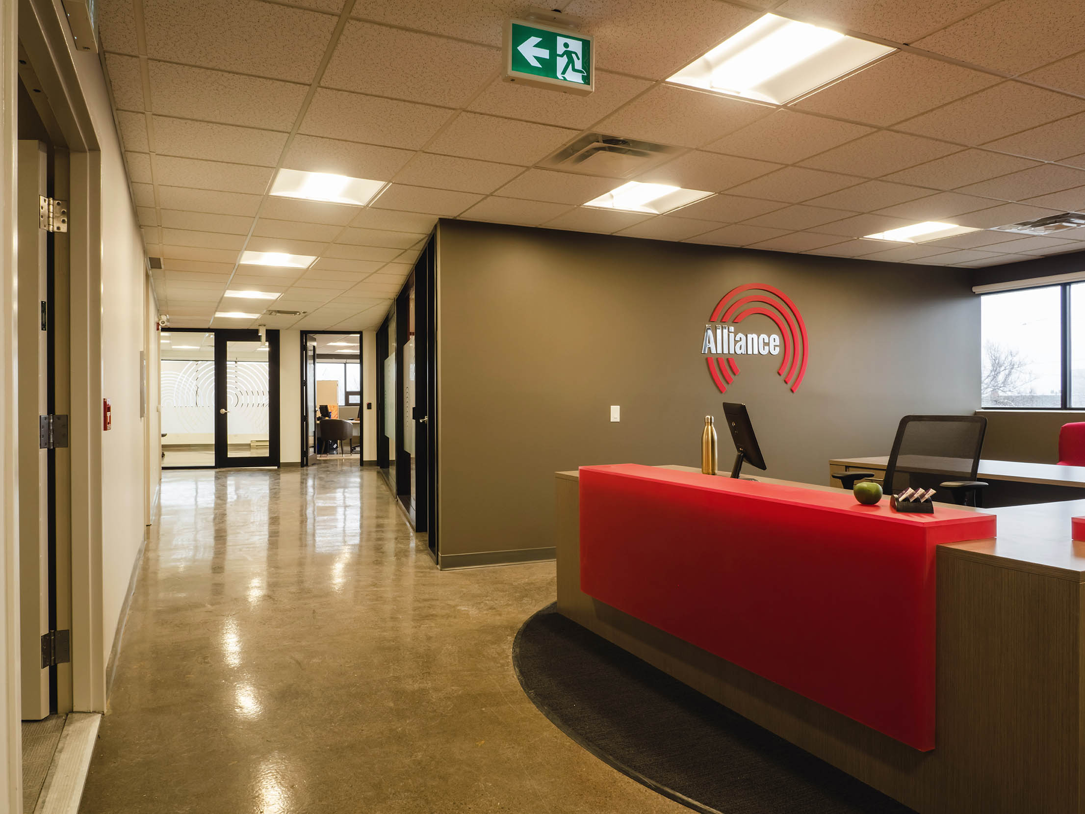 Reception area featuring Alliance Security Team's brand colors and curved desk design.