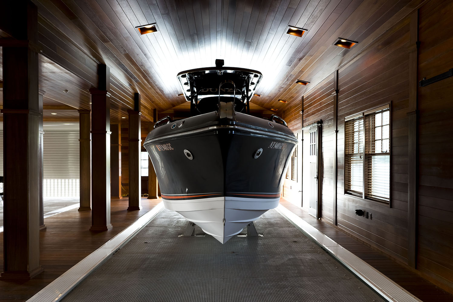 Modern lakefront boathouse interior design – 1000 Islands project by Stone & Associates.