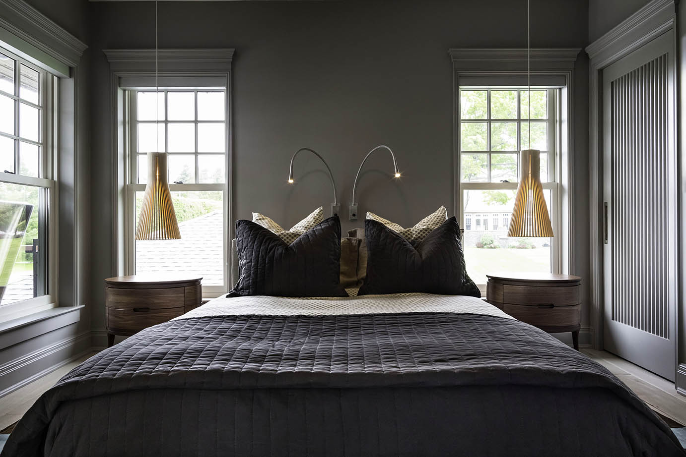 Relaxed, refined bedroom design with deep hues and natural materials