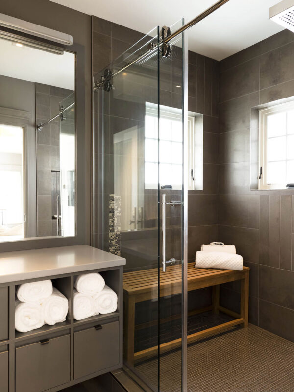Sophisticated boathouse bathroom with tonal depth and warm accents