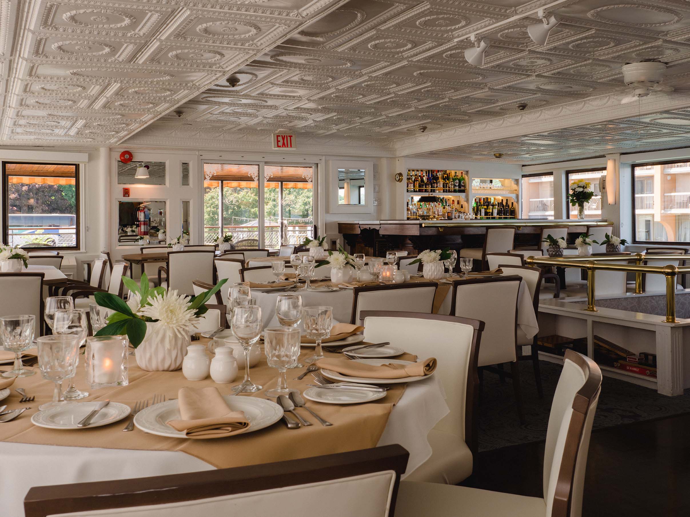 Nostalgic river cruise dining area with wood floors, brass accents, and traditional detailing
