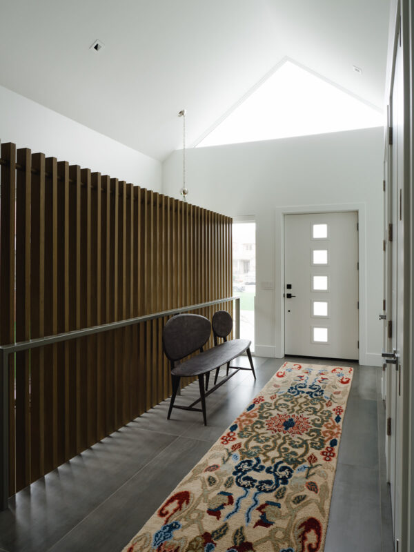 Light-filled foyer with oak guard detail