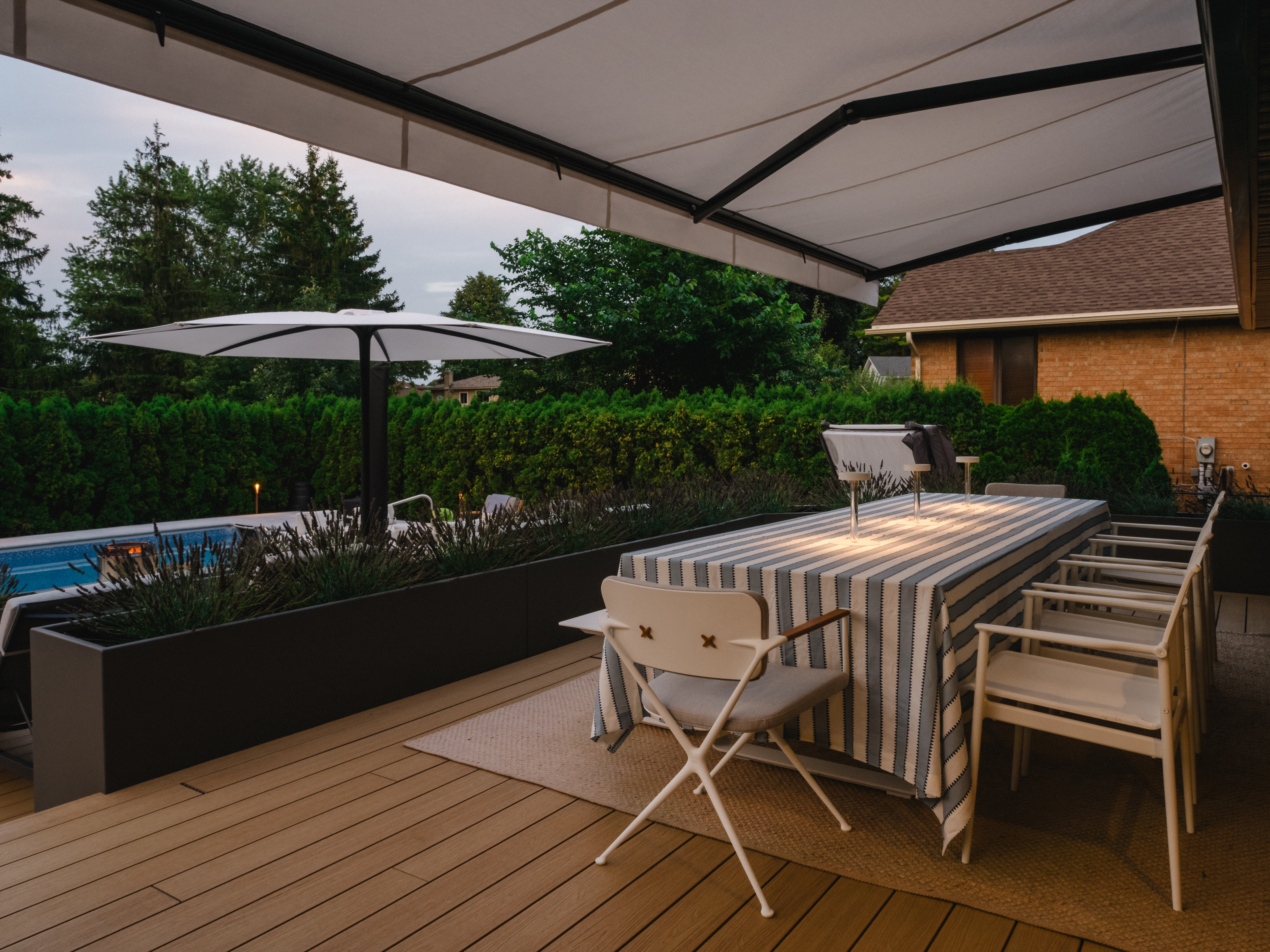 ining deck surrounded by custom planters in modern backyard renovation