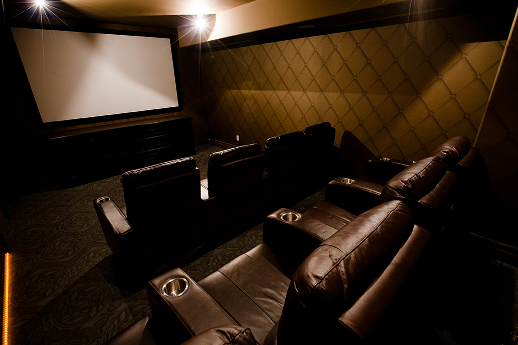 Private condo theatre with leather recliners and a large projection screen