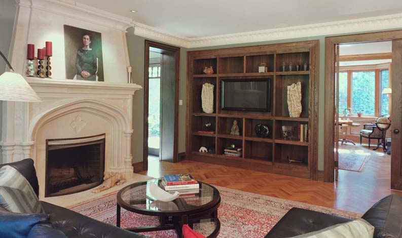 Custom wood built-ins and fireplace surround in a Toronto luxury home, highlighting bespoke craftsmanship and traditional interiors,