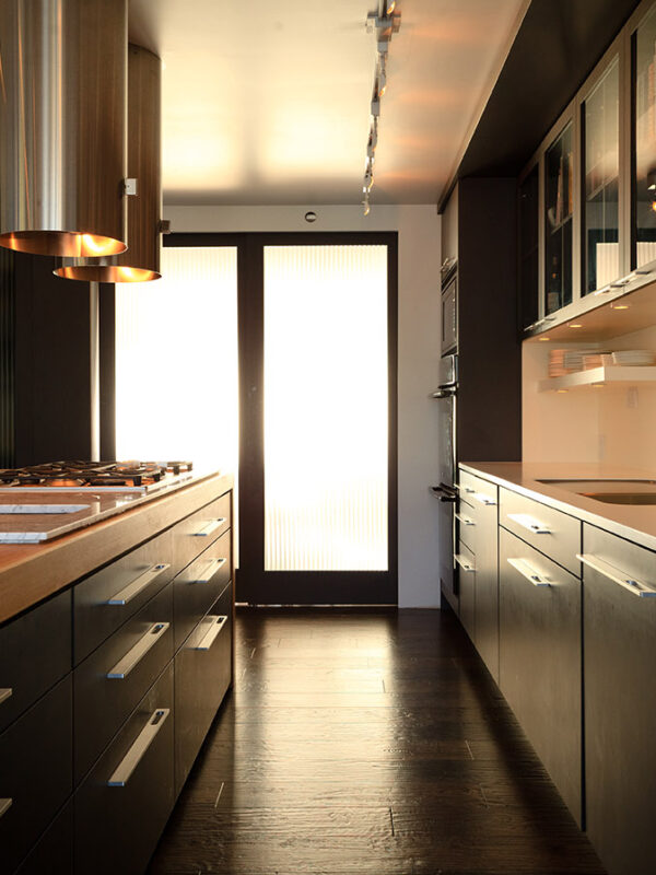 Modern kitchen featuring grey and white oak millwork with stainless appliances