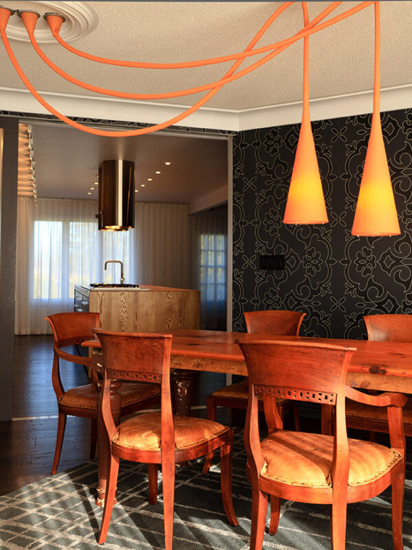 Eclectic dining space blending classic wood furniture and modern lighting