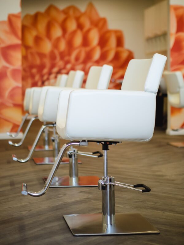 Close-up of salon chair in front of white cabinetry with sleek, modern lines.