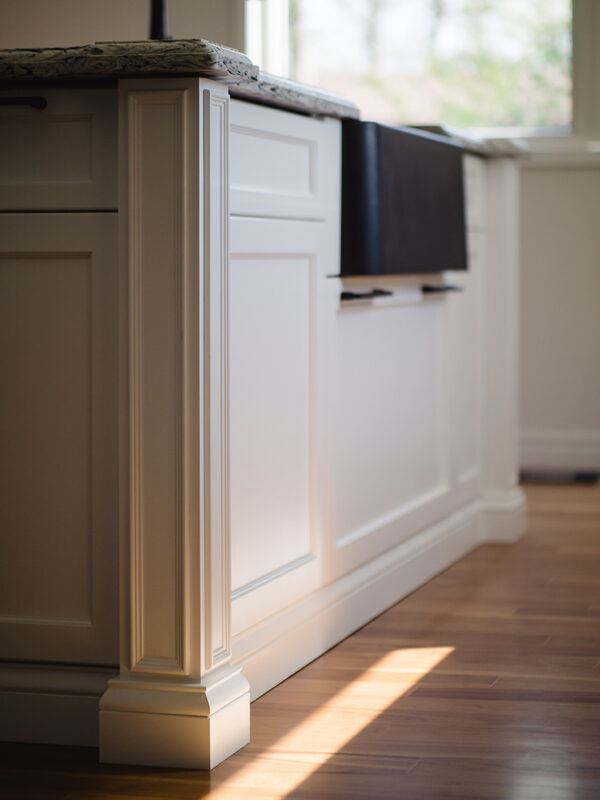 shot of custom island details with black farmhouse sink