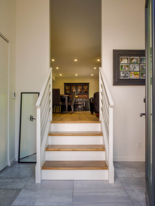 view of interior staircase with cable rail
