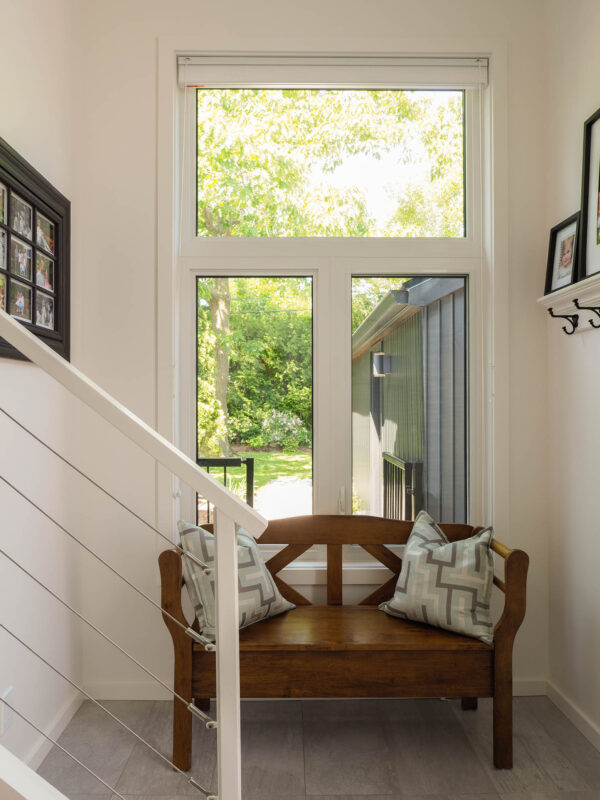 Interior view of window in new addition with wooden bench