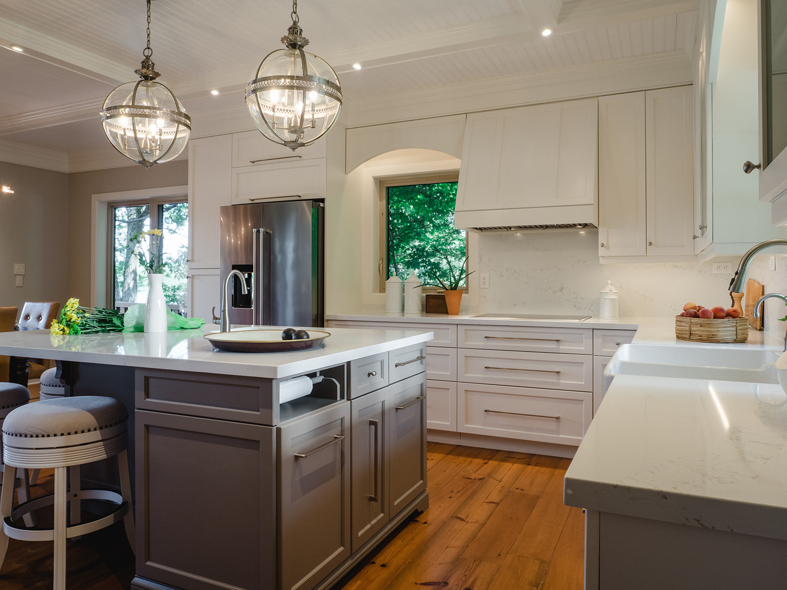 Large kitchen island with charcoal base and white quartz counter