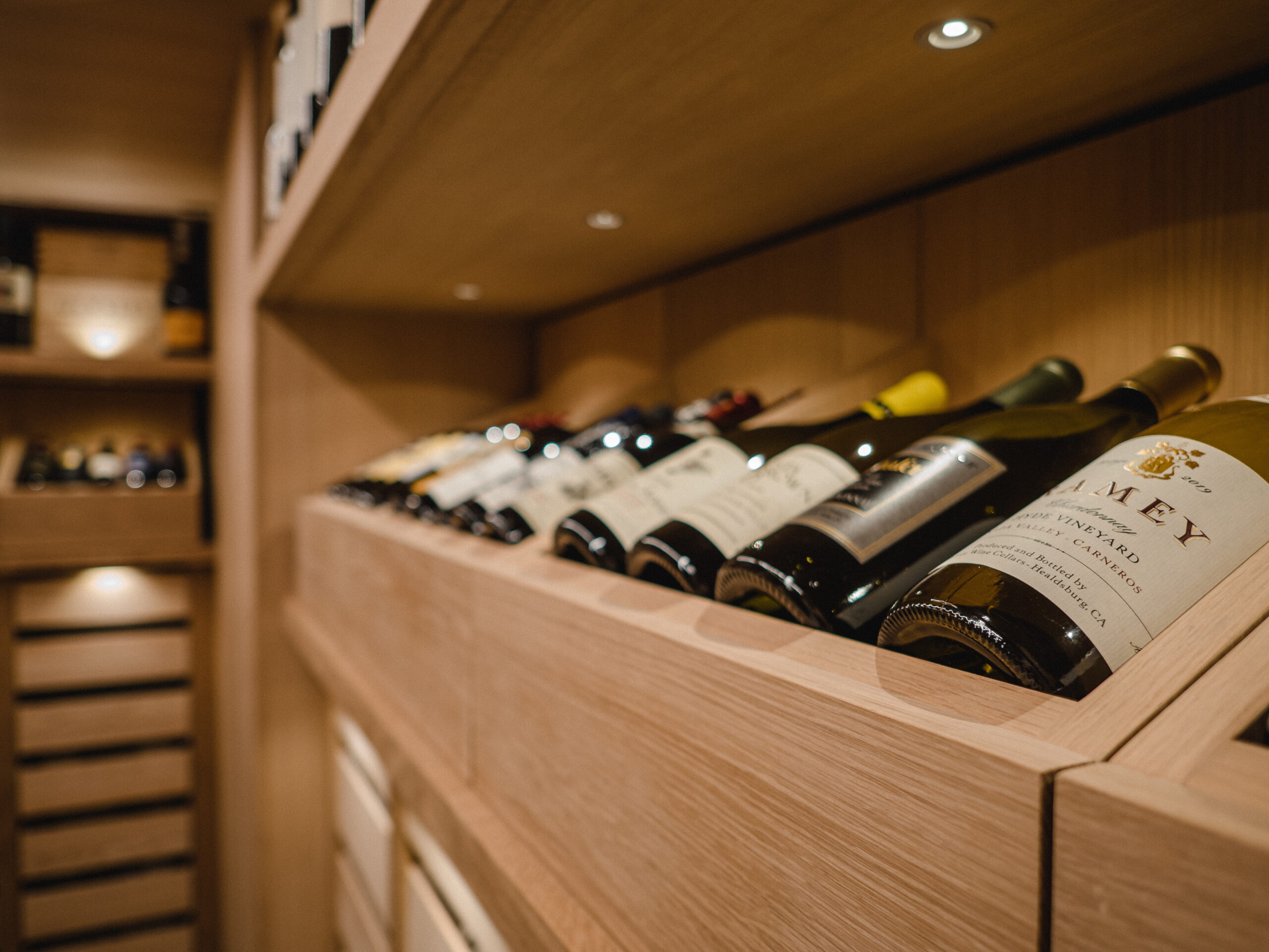 Refined wine cellar interior with seamless white oak detailing