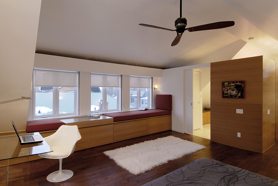 Attic conversion featuring wood floors, custom millwork, and dormer windows